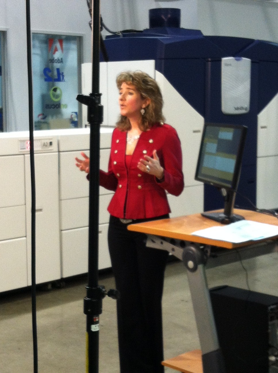 Lisa Rawa, VP, Marketing, PIA, Standing in front of Xerox iGen4